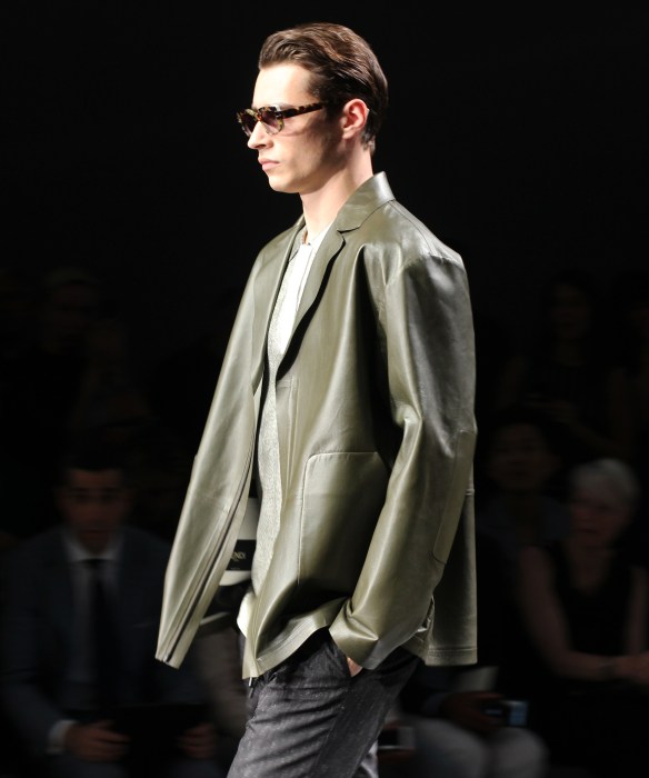 Model Adrian Sahores in an olive green leather jacket and matching metallic shirt